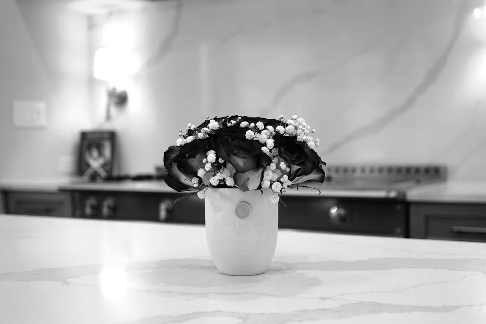 An empty Idlekind vessel used as a vase for a floral arrangement